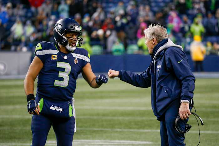 Jan 2, 2022; Seattle, Washington, USA; Seattle Seahawks quarterback Russell Wilson (3) bumps fists with head coach Pete Carroll during the fourth quarter two-minute warning against the Detroit Lions at Lumen Field. Mandatory Credit: Joe Nicholson-USA TODAY Sports